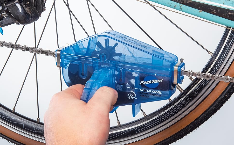 Park Tool chain cleaner scrubbing a road bike chain